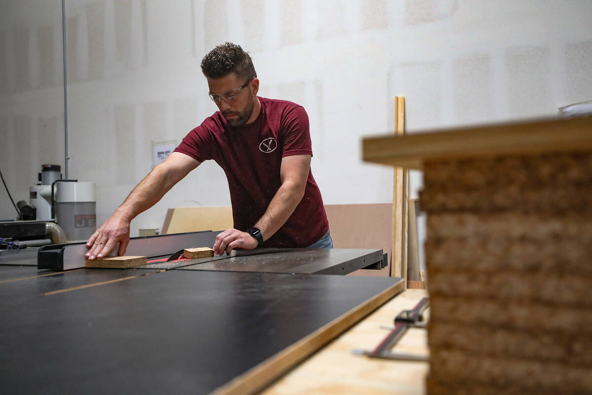 Production supervisor Nico Fenske cuts a tile of used chopsticks at ChopValue’s factory ...