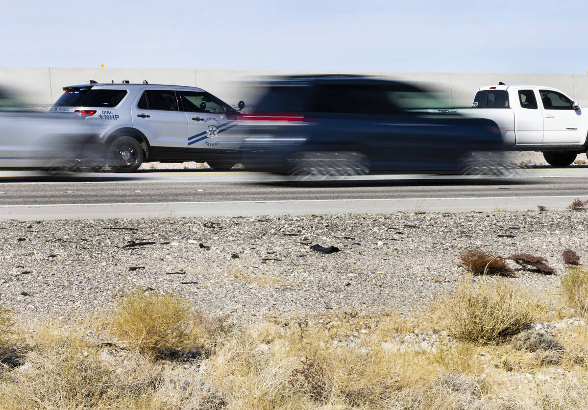 A Nevada Highway Patrol officer writes a citation to a speeding motorist on I-15 near Primm, on ...
