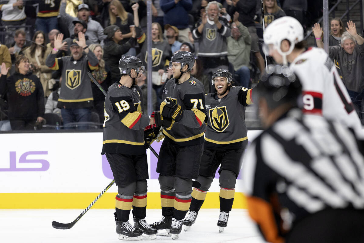 Golden Knights right wing Reilly Smith (19) and center Jonathan Marchessault (81) skate to cong ...