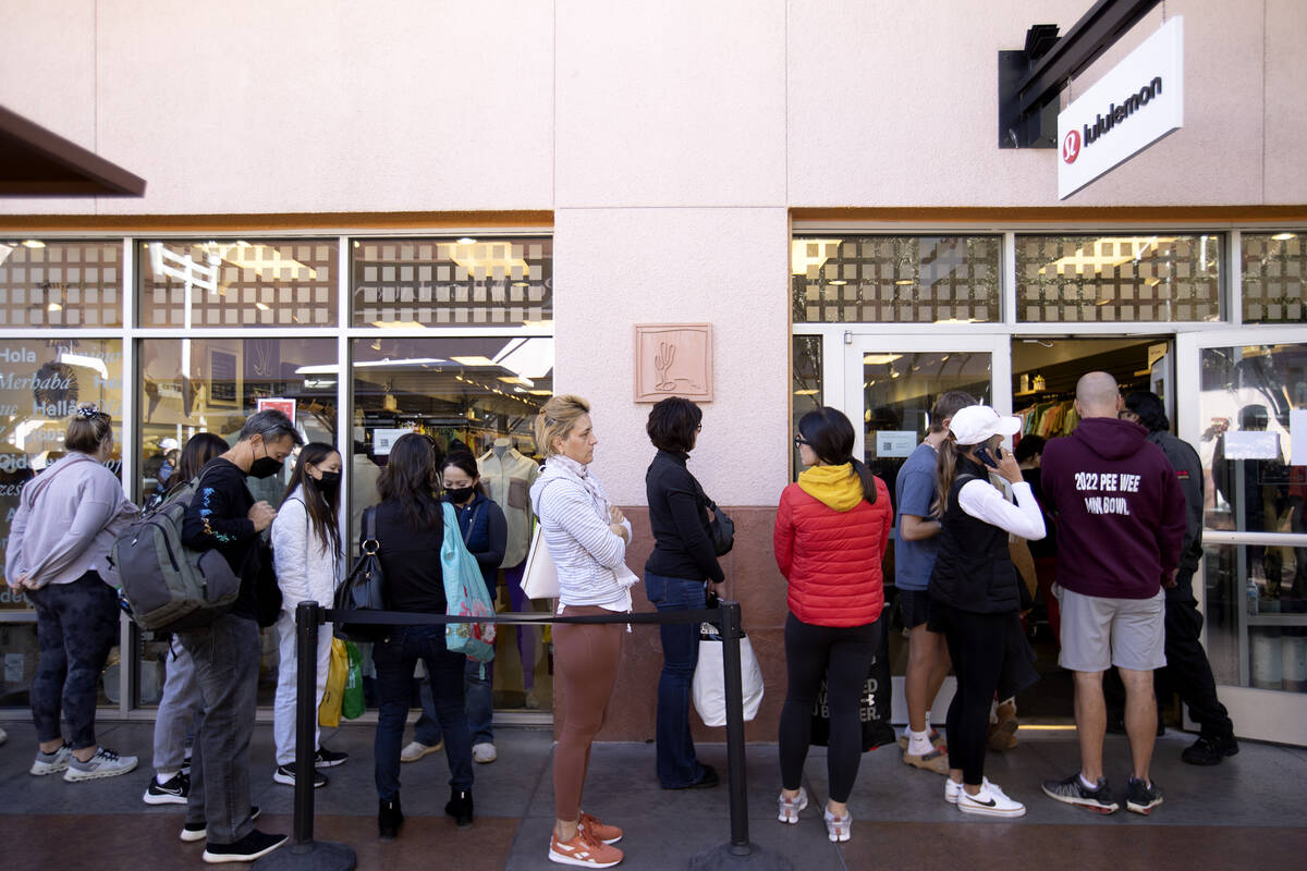 Shoppers wait in line at Lululemon for Black Friday deals at Las Vegas North Premium Outlets on ...