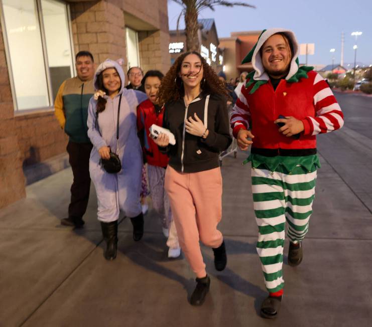 Shoppers run to join the line for Black Friday deals at Walmart Supercenter in Henderson Friday ...