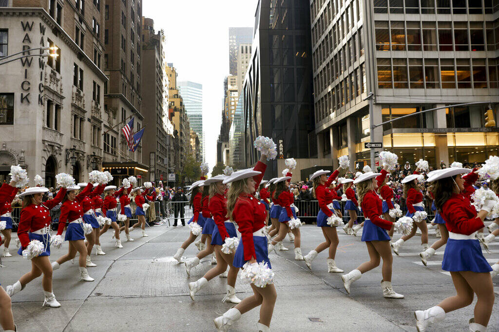 Cheerleaders make their way down Sixth Avenue during the Macy's Thanksgiving Day Parade, Thursd ...