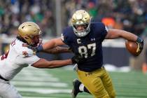 Notre Dame tight end Michael Mayer (87) runs past Boston College defensive back Jaiden Woodbey ...