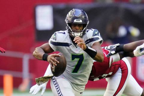 Seattle Seahawks quarterback Geno Smith runs with the ball against the Arizona Cardinals during ...