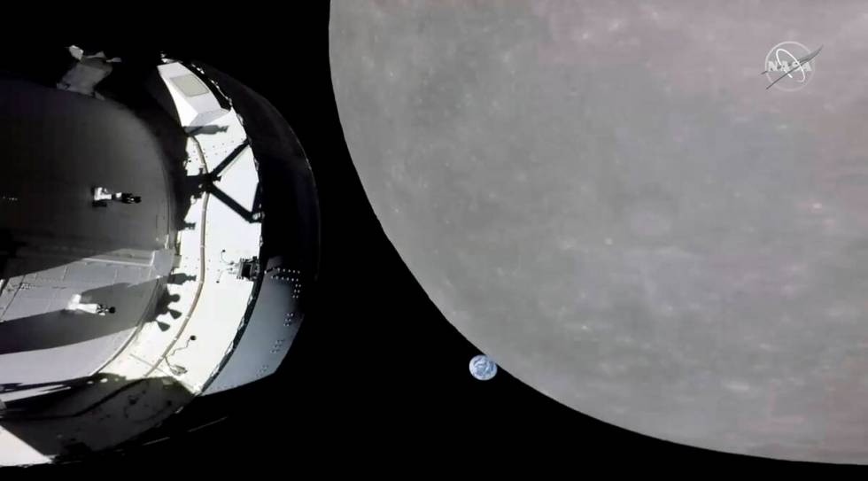 This screengrab from NASA TV shows NASA's Orion capsule, left, nearing the moon, right, Monday, ...