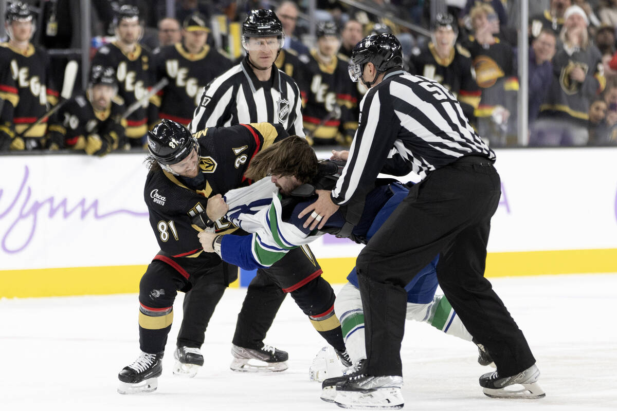Golden Knights center Jonathan Marchessault (81) fights with Canucks right wing Conor Garland ( ...