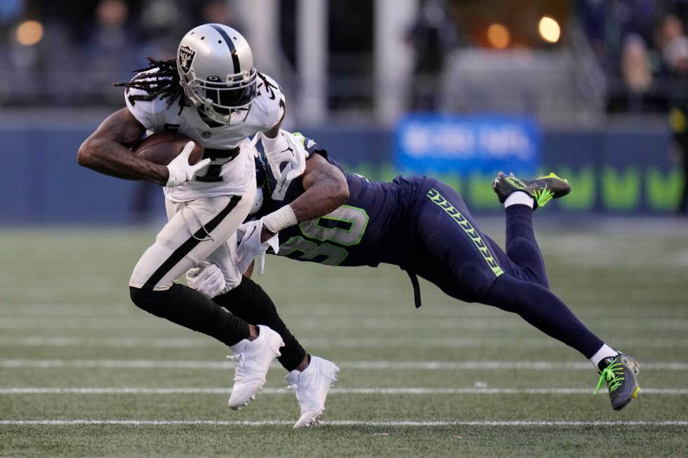 Las Vegas Raiders wide receiver Davante Adams runs after a catch against the Seattle Seahawks d ...