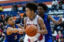 Bishop Gorman's John Mobley Jr. (3) and Keenan Bey (2) defend against Liberty High's Angelo Kam ...