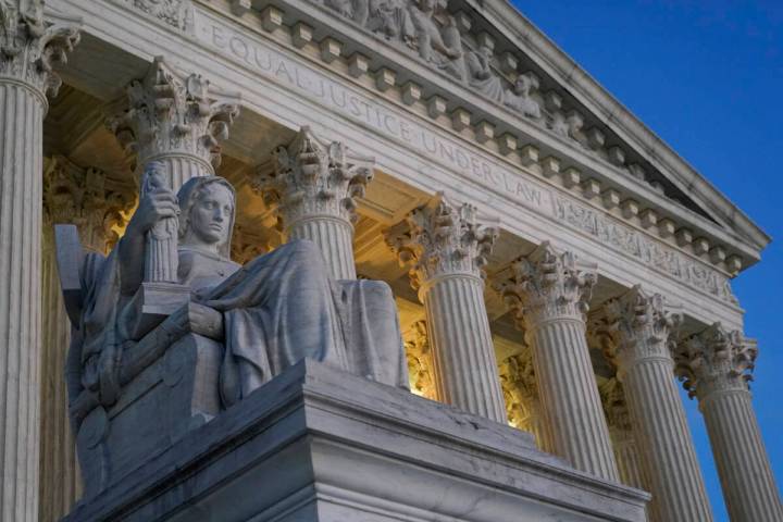 Light illuminates part of the Supreme Court building on Capitol Hill in Washington, Wednesday, ...
