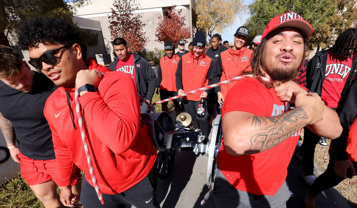 UNLV Football players, including offensive lineman Leif Fautanu, left, and defensive lineman Na ...