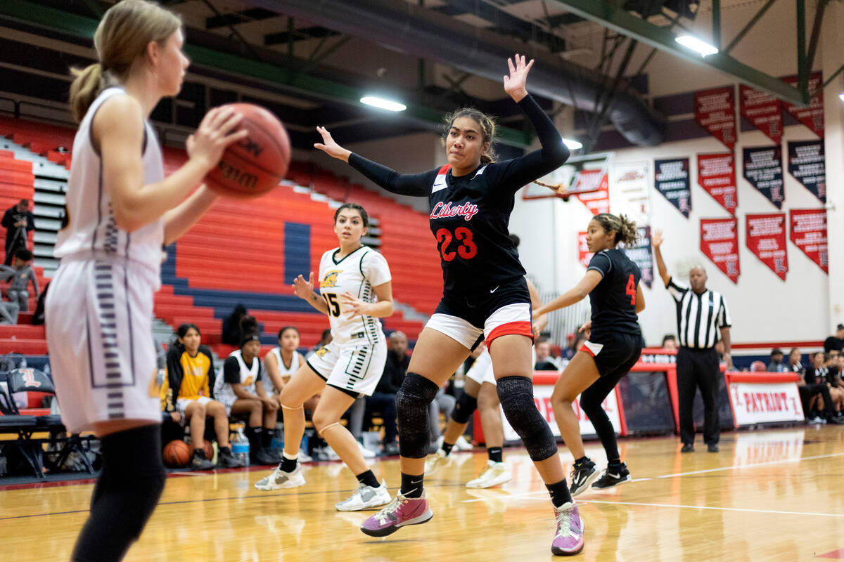 Liberty’s Adrienne Puletasi (23) guards Clark’s Charlotte Gillett, left, during a ...