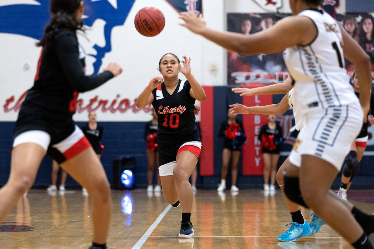 Liberty’s Alofa Eteuine (10) passes up the court during a high school girls basketball g ...