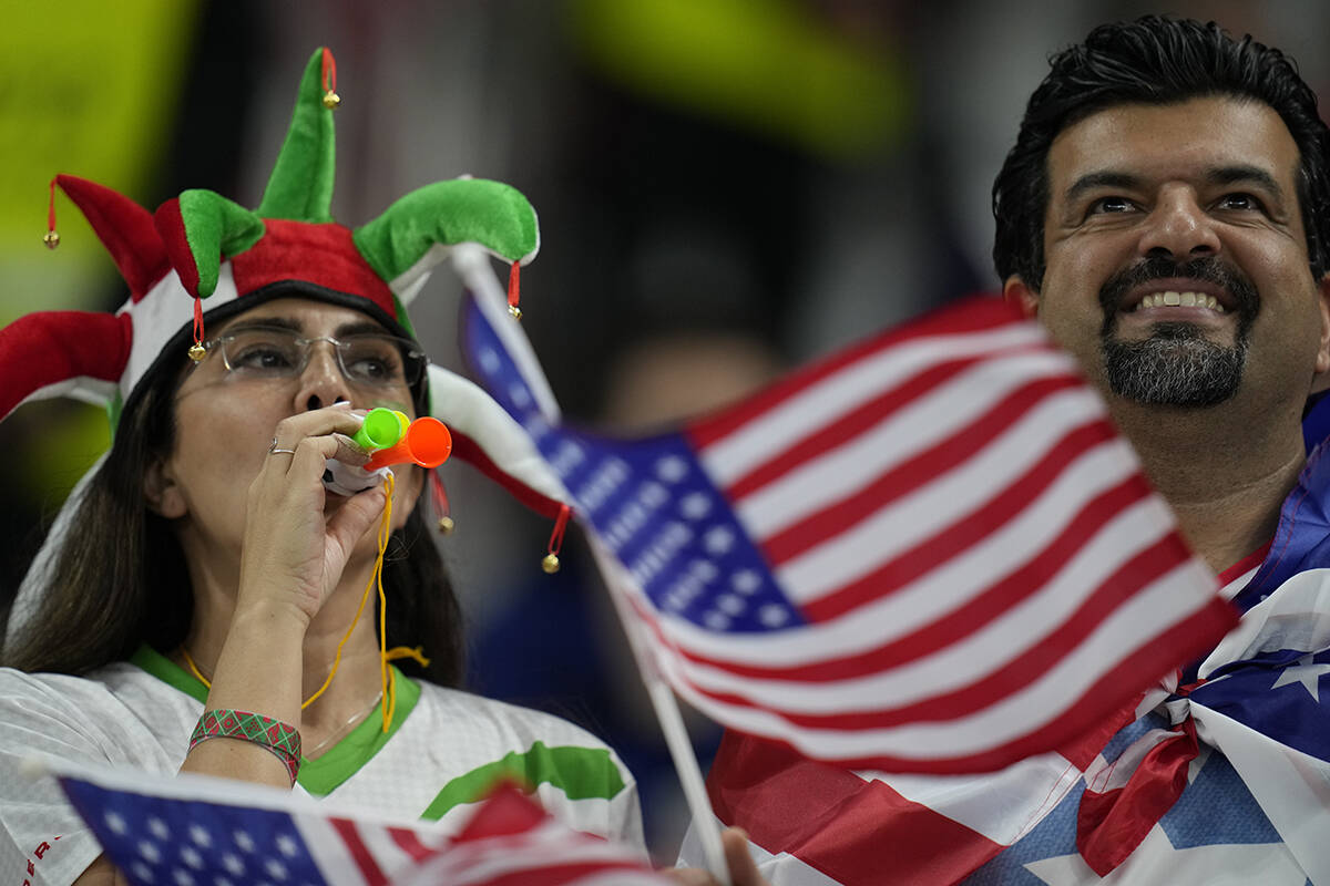 Supporters cheer prior to the World Cup group B soccer match between Iran and the United States ...