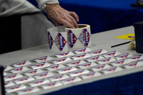 A poll worker lays out I Voted stickers at a polling place Tuesday, Nov. 8, 2022, in Las Vegas. ...