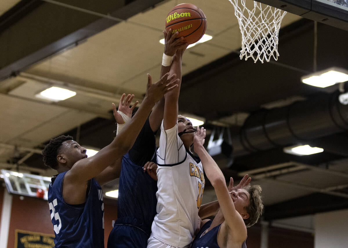 Clark’s Jayonni Durrough, second from right, shoots against Centennial’s Tremayne ...