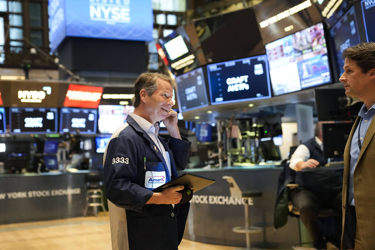 Traders work on the floor at the New York Stock Exchange in New York, Monday, Nov. 28, 2022. (A ...