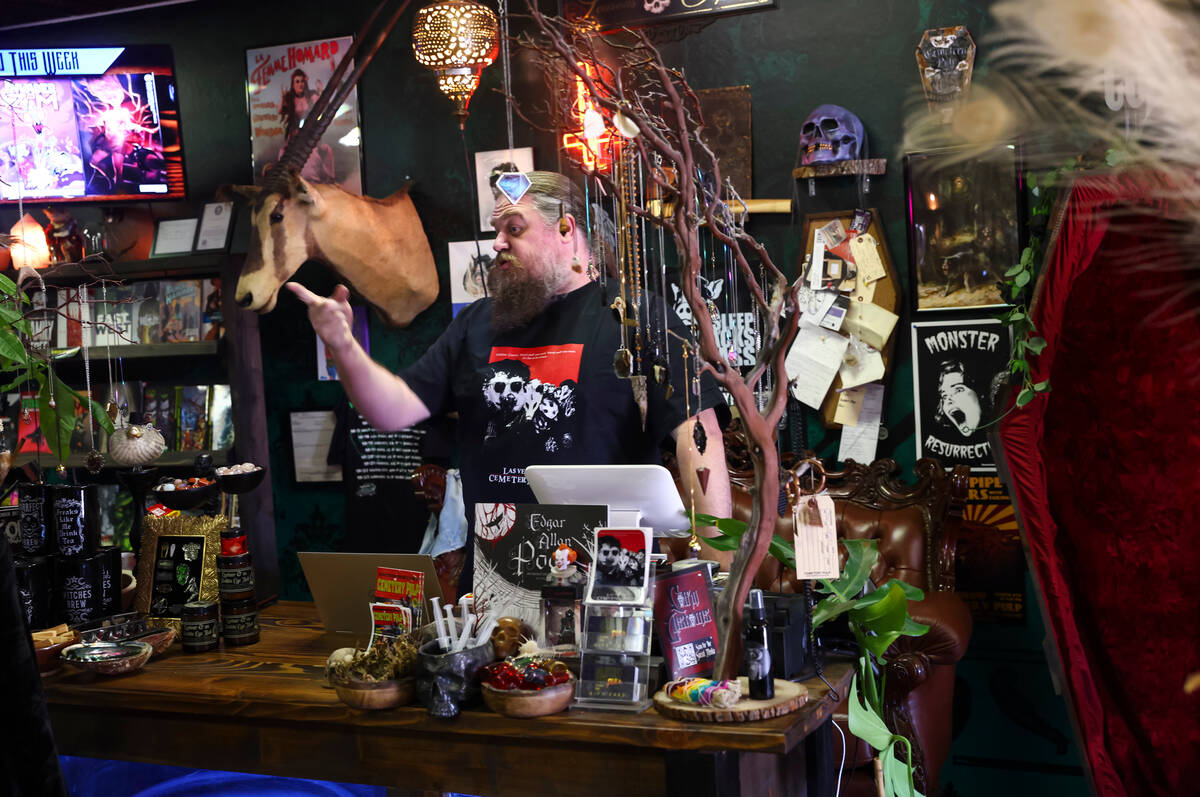 Chris Kmit, co-owner at Cemetery Pulp, a shop of oddities, comics and more, helps customers on ...