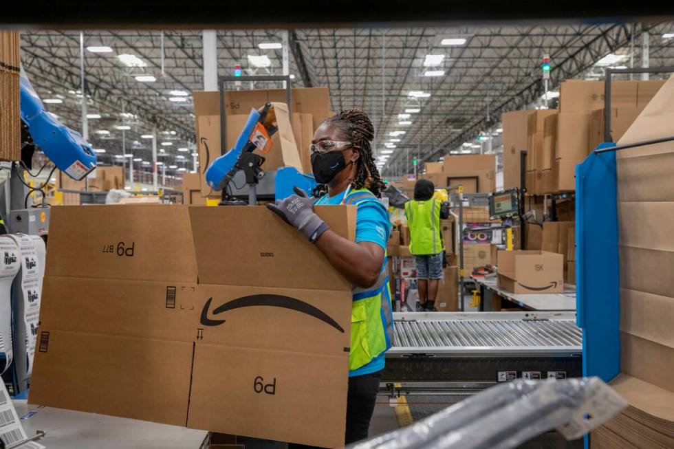 Amazon associate Lola Wickett packages products at an Amazon warehouse in North Las Vegas on Th ...