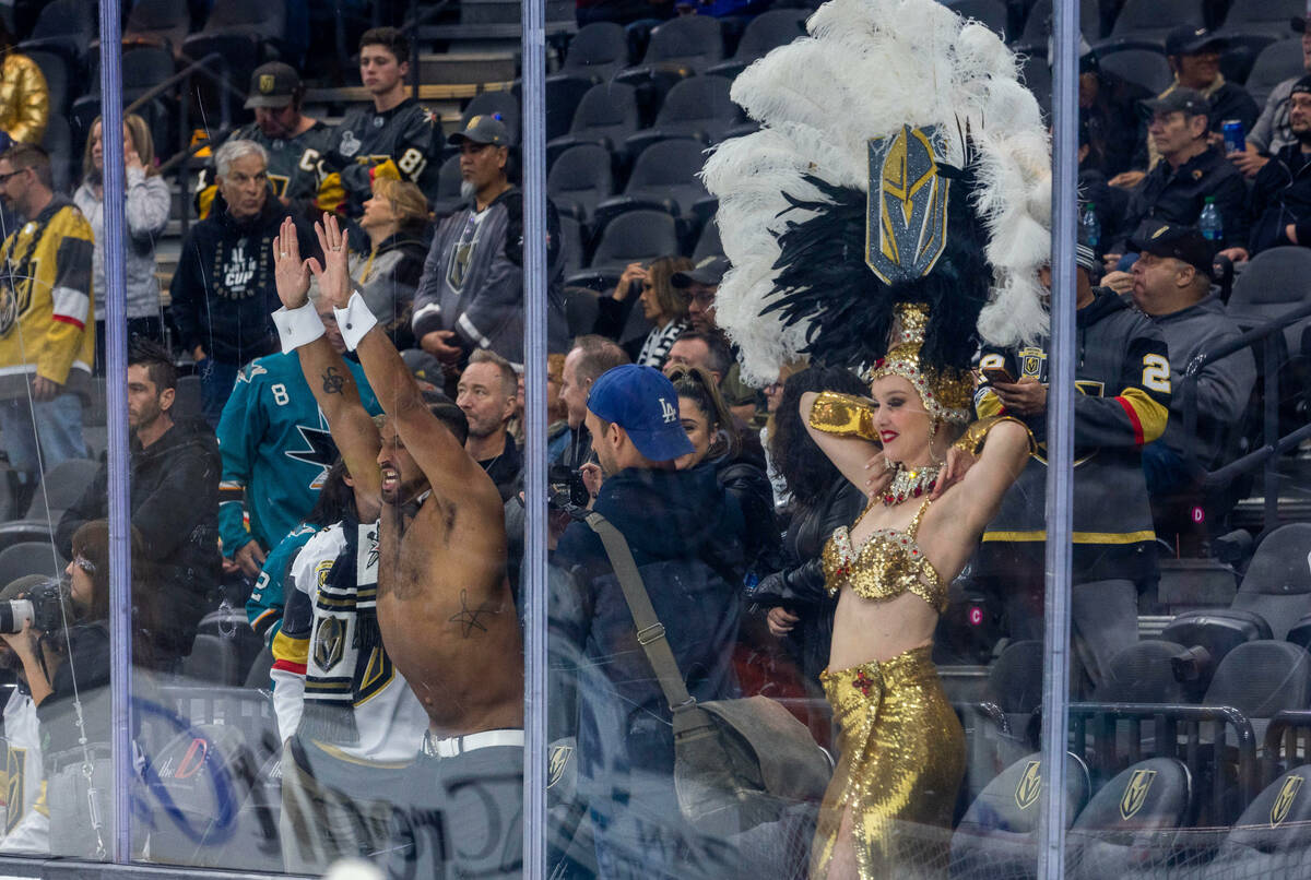 A Chippendales and Golden Belles dancer entertain the crowd before the first period of the Gold ...