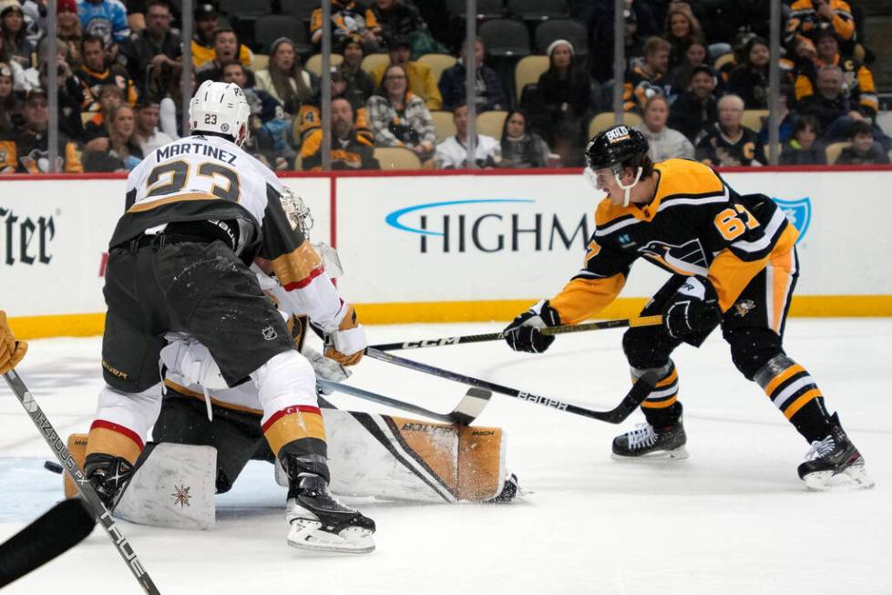 Pittsburgh Penguins' Rickard Rakell (67) gets a shot behind Vegas Golden Knights goaltender Log ...