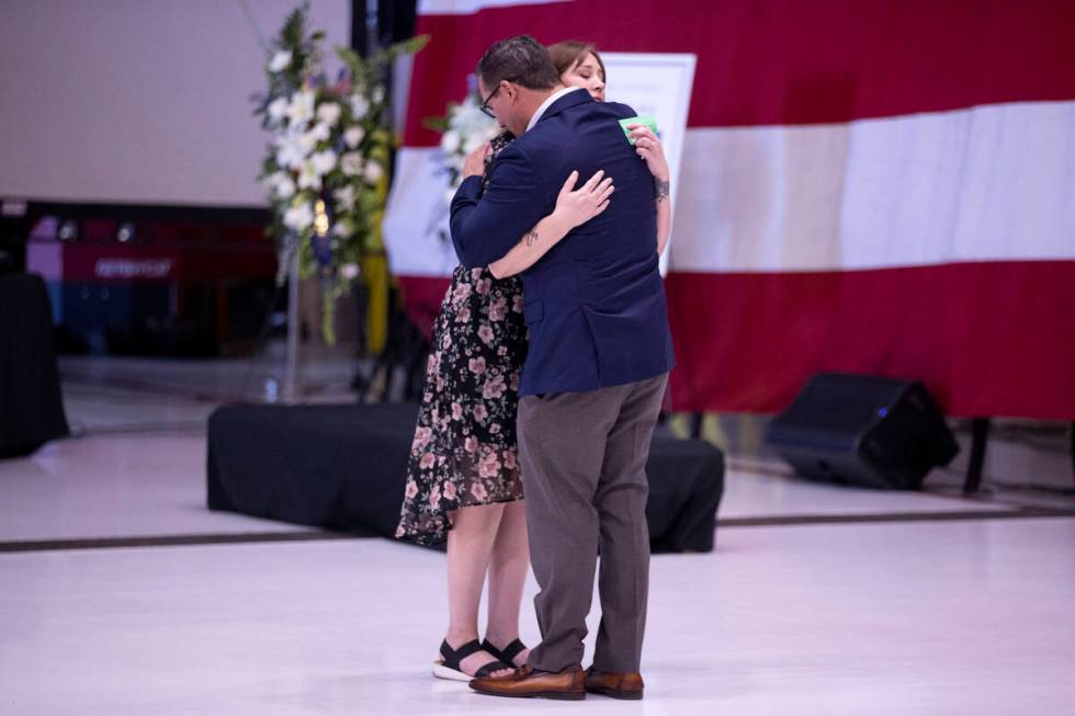 Jessica Cortez, left, embraces Chris Fellure, father of Brooklynn Fellure, a senior airman who ...