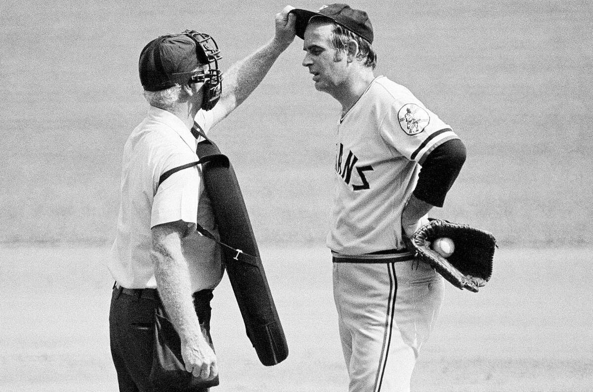 Home plate umpire John Flaherty checks Cleveland Indians pitcher Gaylord Perry's cap for an ill ...