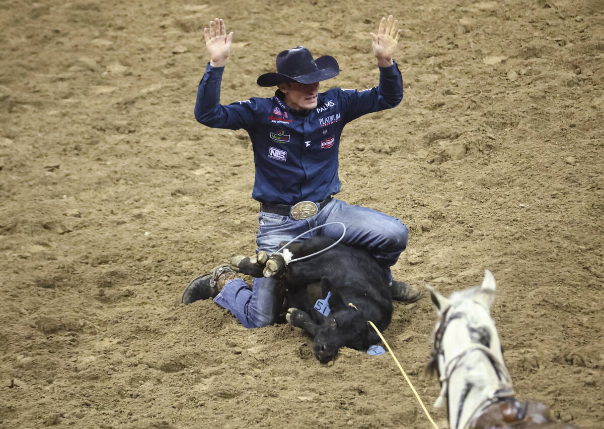 Tuf Cooper, of Decatur, Texas competes in tie-down roping during the first night of the Nationa ...
