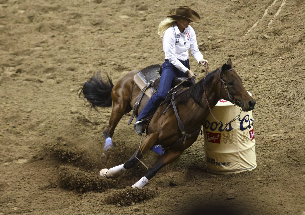 Wenda Johnson, of Pawhuska, Okla., competes in barrel racing during the first night of the Nati ...