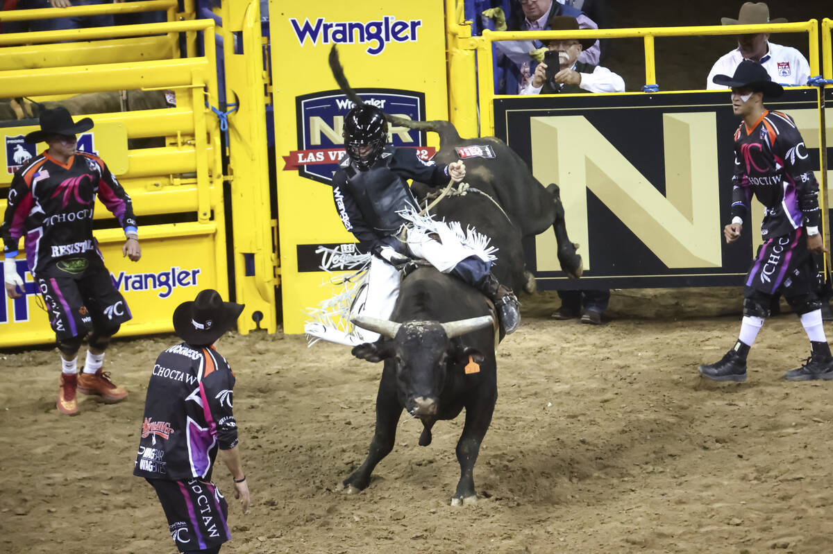 Trey Kimzey, of Strong City, Okla., rides Mad Money while competing in bull riding during the f ...