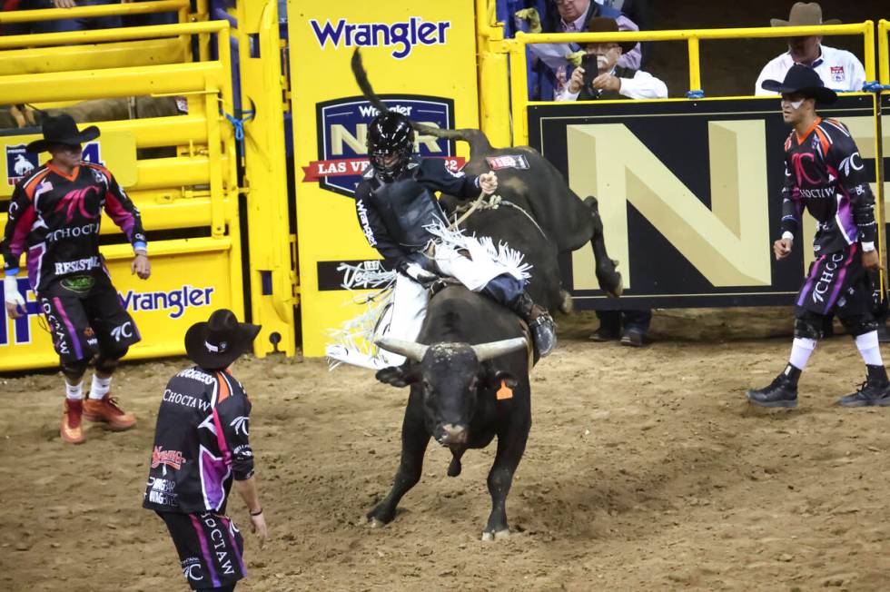 Trey Kimzey, of Strong City, Okla., rides Mad Money while competing in bull riding during the f ...
