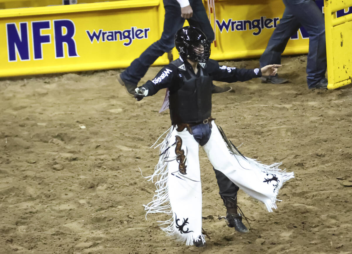 Trey Kimzey, of Strong City, Okla., reacts after riding Mad Money while competing in bull ridin ...