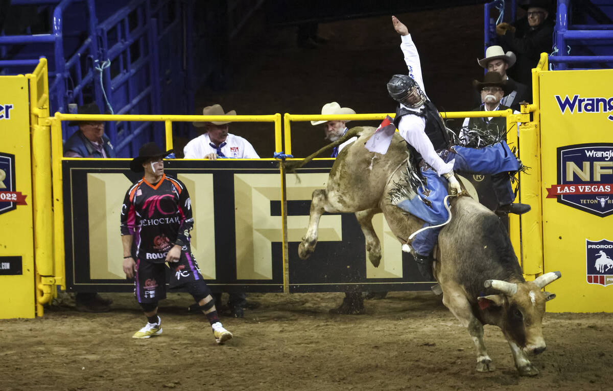 Jeff Askey, of Athens, Texas, competes in bull riding during the first night of the National Fi ...