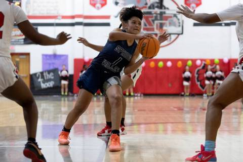 Spring Valley’s Mia Ervin (1) looks to pass while Las Vegas guards her during a girls hi ...