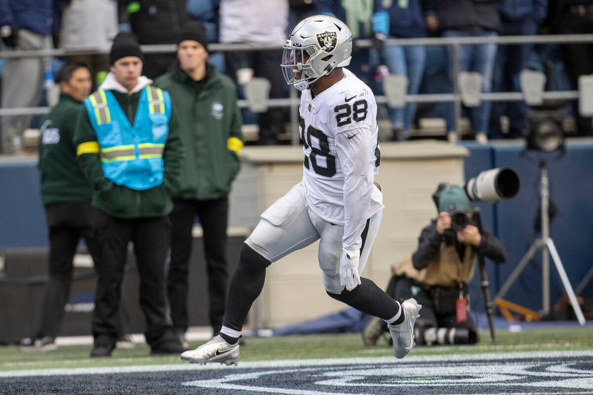 Raiders running back Josh Jacobs (28) scores a touchdown during the first half of an NFL game a ...