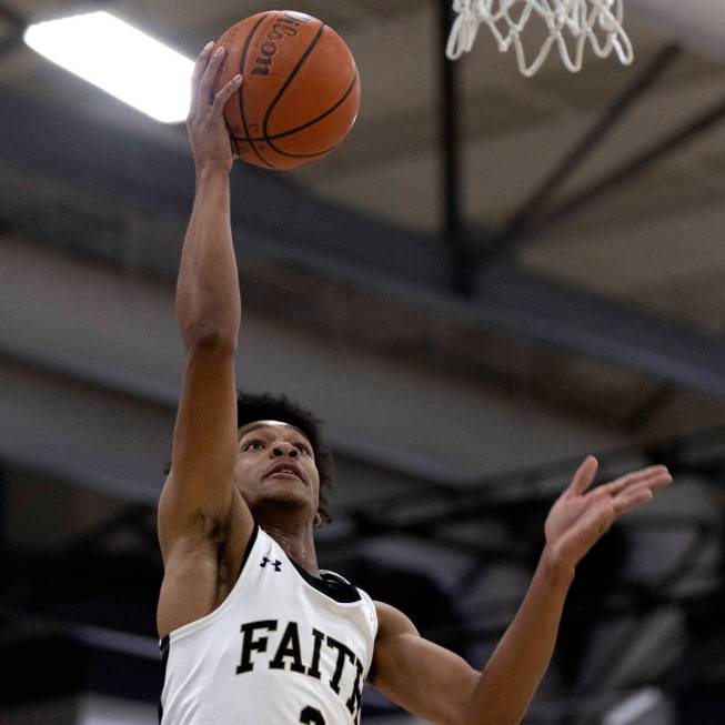 Faith Lutheran’s LJ Mercurius (2) shoots against Mojave during a boys high school basket ...