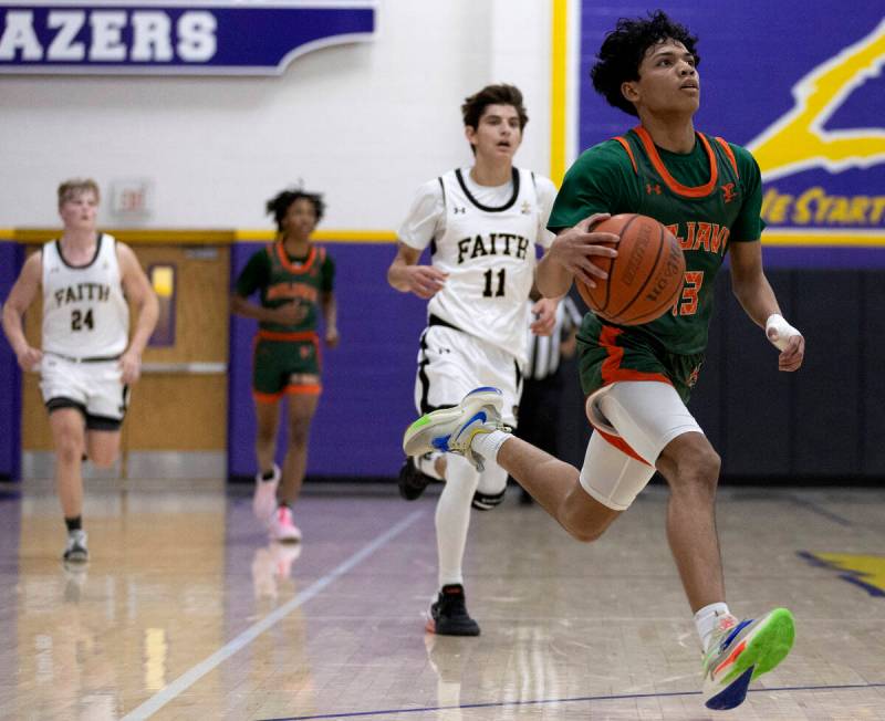 Mojave’s Nathan Sherrard (13) runs to shoot followed by Faith Lutheran’s Tyler Ot ...