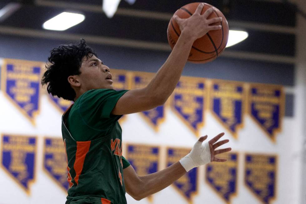 Mojave’s Nathan Sherrard (13) shoots against Faith Lutheran during a boys high school ba ...