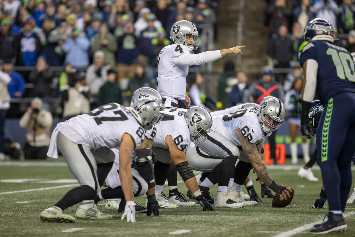 Raiders quarterback Derek Carr (4) calls out instructions from the line of scrimmage during ove ...