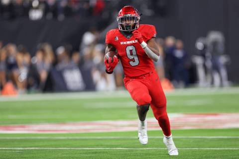 UNLV Rebels running back Aidan Robbins (9) runs the ball against the Nevada Wolf Pack in the se ...