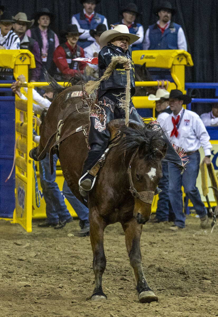 Lefty Holman of Visalia, CA., rides Wall Street to a winning score in Saddle Bronc Riding durin ...