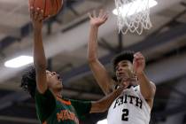 Mojave’s Giali Chapman (2) shoots against Faith Lutheran’s LJ Mercurius (2) duri ...