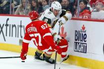 Vegas Golden Knights defenseman Zach Whitecloud (2) knocks over Detroit Red Wings left wing Dav ...