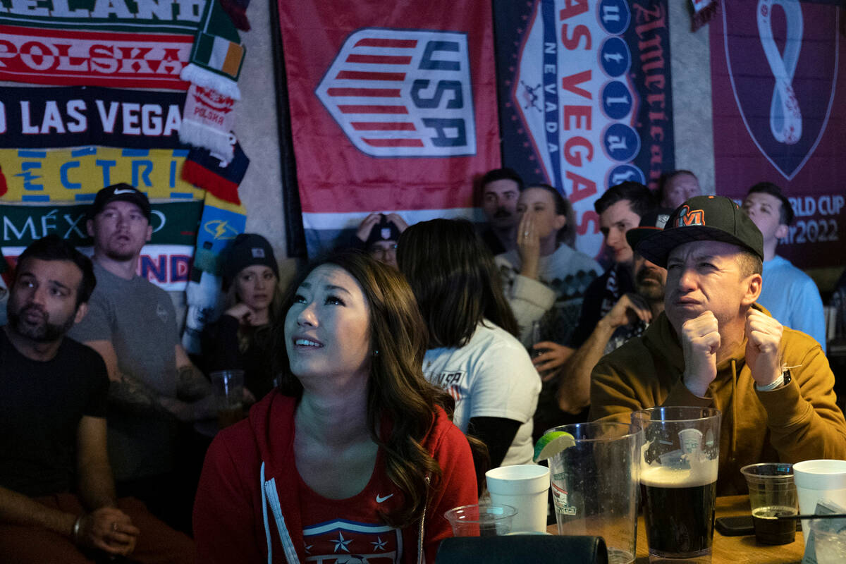 Ami Khauv, center left, and Brian Schulz, right, react as the Netherlands scores in the final m ...