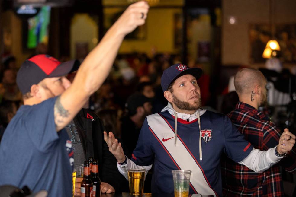 Soccer fans react while watching the World Cup round of 16 soccer match between the United Stat ...