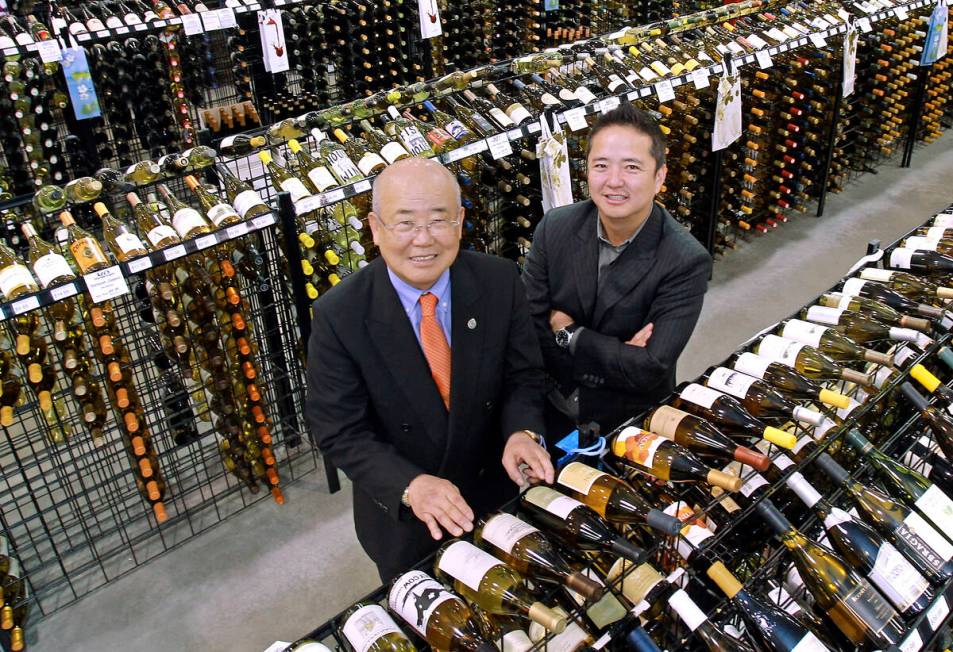 Hae Un Lee, CEO of Lee's Liquor, from left, poses with his son Kenny Lee, President, in their s ...