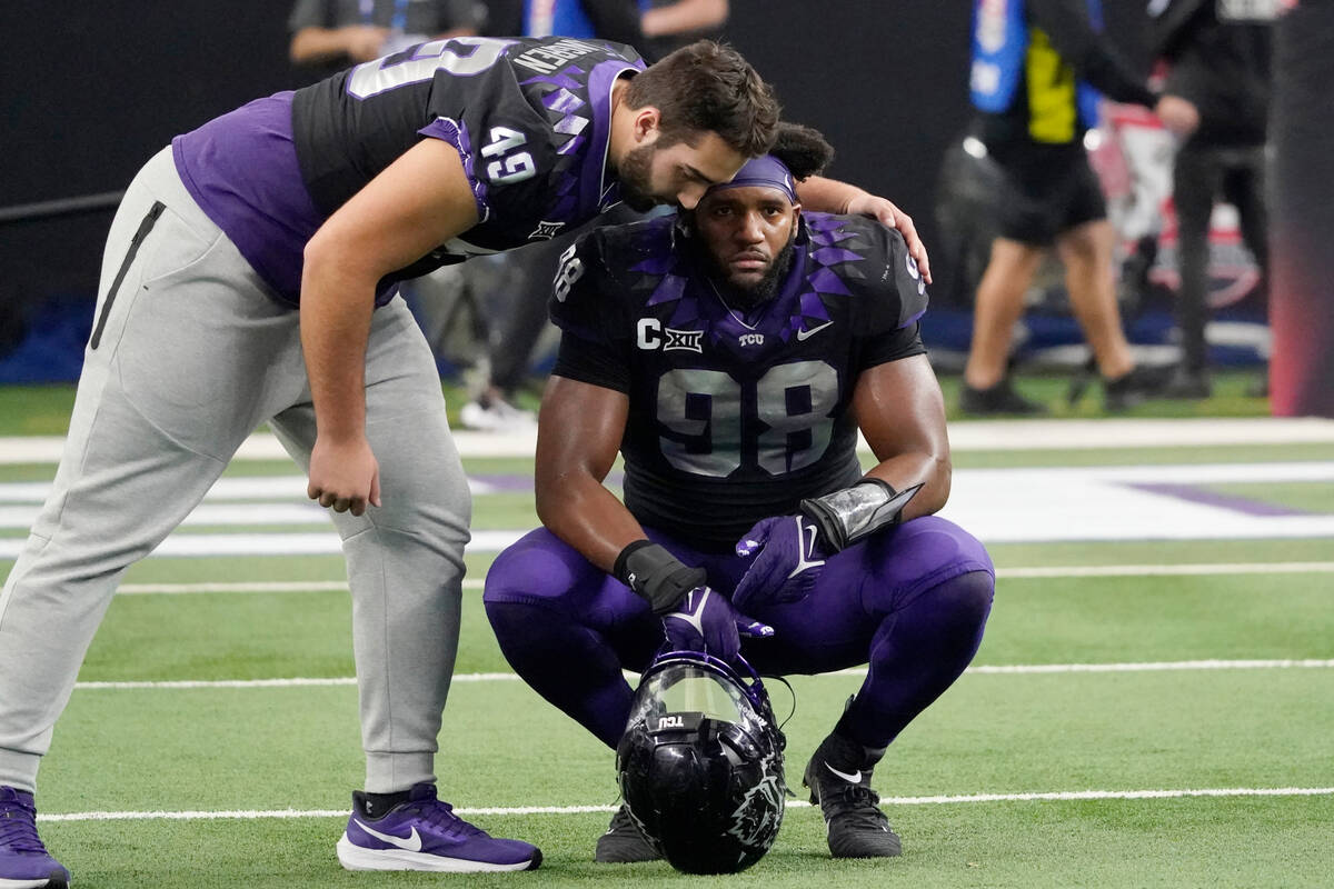 TCU's Connor Lingren (49) consoles teammate Dylan Horton (98) after Kansas State defeated them ...