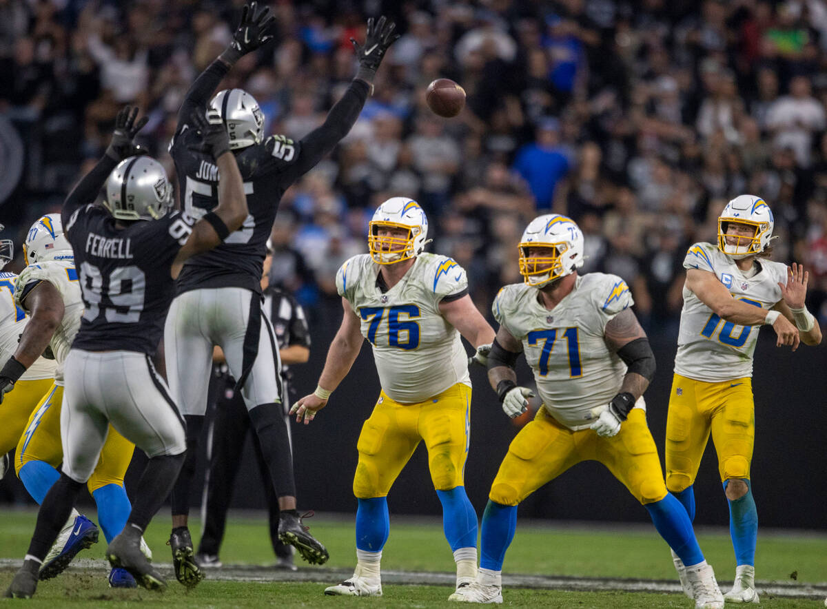 Raiders defensive end Chandler Jones (55) goes up to deflect a pass from Los Angeles Chargers q ...