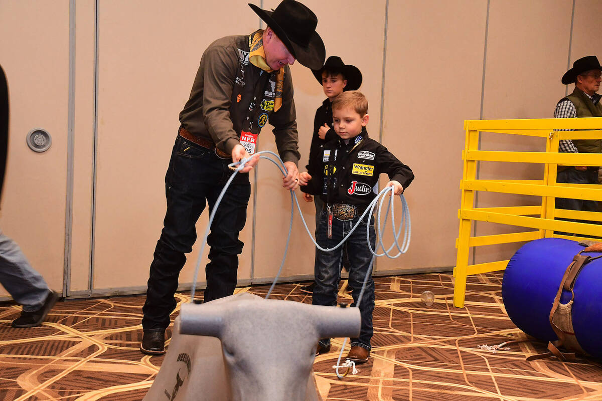 Wrangler NFR team roper Chad Masters gives Braxton Hallums, a youngster battling cancer, a less ...