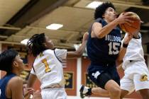 Centennial’s Elijah Burney (15) jumps to shoot against Clark’s Mario Allen ( ...