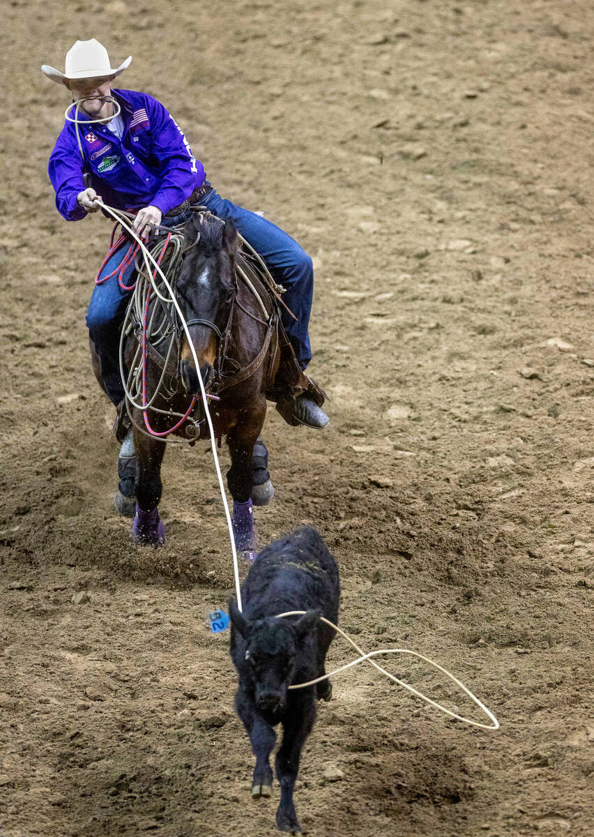 Kincade Henry of Mount Pleasant, TX., ropes a calf as he competes during Tie-Down Roping in the ...
